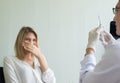 Senior doctor prepare giving vaccine to scared young woman patient with injection or syringe at hospital Royalty Free Stock Photo