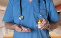 Senior doctor in scrubs with Oxycodone tablets Royalty Free Stock Photo