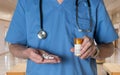 Senior doctor in scrubs with RX tablets Royalty Free Stock Photo