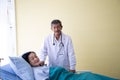 Senior doctor smile in uniform with his woman patient