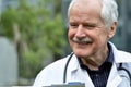 Senior doctor smiling to the patient while giving the diagnosis. Royalty Free Stock Photo