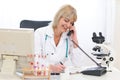 Senior doctor woman speaking phone at office Royalty Free Stock Photo