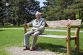 Senior dozing on bench Royalty Free Stock Photo