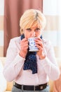 Senior drinking tea to cure her flu Royalty Free Stock Photo