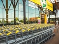 Senior Dutch woman at main entrance of Ranzijn yellow supermarket