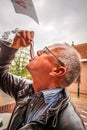 A Senior eating a Herring Zoute Haring in the city of Elburg in the Netherlands,