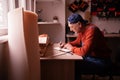 Senior elderly Carpenter writing project notes in woodwork workshop. Profession and small business concept Royalty Free Stock Photo