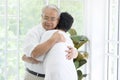 Senior elderly couple are hugging in home