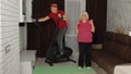 Senior elderly couple using orbitrek, doing workout weight lifting sport dumbbells exercises at home Royalty Free Stock Photo