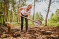 Senior elderly gardener woman digging caring ground level at summer farm countryside outdoors using garden tools rake Royalty Free Stock Photo