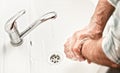 Senior elderly man his hands and wrist with soap under tap water faucet, detail photo. Can be used as hygiene illustration concept