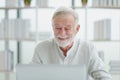 The senior elderly man work from home sitting and relaxing with happy and smiling emotion Royalty Free Stock Photo