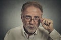 Senior elderly skeptical man with eyeglasses Royalty Free Stock Photo