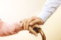 Mature female in elderly care facility gets help from hospital personnel nurse. Close up of aged wrinkled hands of senior woman. G Royalty Free Stock Photo