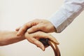 Mature female in elderly care facility gets help from hospital personnel nurse. Close up of aged wrinkled hands of senior woman. G Royalty Free Stock Photo