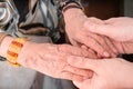 Senior or eldery assistance concept. Young man holds hands of senior woman Royalty Free Stock Photo