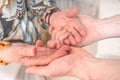 Senior or eldery assistance concept. Young man holds hands of senior woman Royalty Free Stock Photo