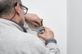 Senior electrician connecting power wires to the plug on a house.