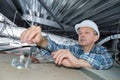 Senior electrician at work in roof space Royalty Free Stock Photo