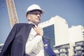 Senior elegant builder man in suit at construction site on sunny Royalty Free Stock Photo