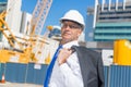 Senior elegant builder man in suit at construction site on sunny summer day Royalty Free Stock Photo