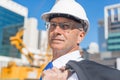 Senior elegant builder man in suit at construction site on sunny summer day Royalty Free Stock Photo