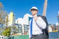 Senior elegant builder man in suit at construction site on sunny summer day Royalty Free Stock Photo