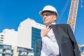 Senior elegant builder man in suit at construction site on sunny summer day Royalty Free Stock Photo