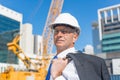 Senior elegant builder man in suit at construction site on sunny summer day Royalty Free Stock Photo