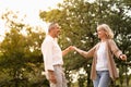 Senior elegant caucasian couple dancing looking at each other feeling love and cherish on their anniversary in the park with copy Royalty Free Stock Photo