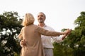 Senior elegant caucasian couple dancing looking at each other feeling love and cherish on their anniversary in the park with copy Royalty Free Stock Photo