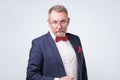 Senior european man in blue suit and glasses looking at camera