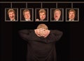 The senior european man in front of posters with his faces.