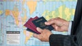 UK or US Citizen with passports and world map of timezones Royalty Free Stock Photo