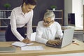 Senior executive and young assistant working in office and planning work schedule Royalty Free Stock Photo