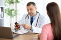 Senior experienced doctor showing pills to female patient Royalty Free Stock Photo