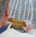Senior expert craftsman creates a handmade wicker basket