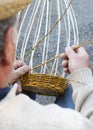 Senior expert craftsman creates a wicker basket