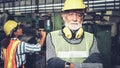 Senior factory worker or engineer close up portrait in factory