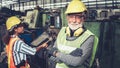 Senior factory worker or engineer close up portrait in factory