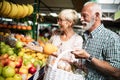 Senior family couple choosing bio food fruit and vegetable on the market during weekly shopping Royalty Free Stock Photo