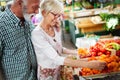 Senior family couple choosing bio food fruit and vegetable on the market during weekly shopping Royalty Free Stock Photo