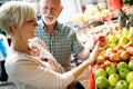 Senior family couple choosing bio food fruit and vegetable on the market during weekly shopping Royalty Free Stock Photo