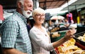 Senior family couple choosing bio food fruit and vegetable on the market during weekly shopping Royalty Free Stock Photo