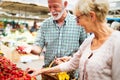 Senior family couple choosing bio food fruit and vegetable on the market during weekly shopping Royalty Free Stock Photo