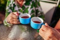 Senior family couple drinking tea in cafe. People enjoying beverages outdoors. Close-up of cups Royalty Free Stock Photo