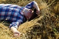 Senior farmer in the hay. Senior taking a break and relaxing on a hay on an summer day. Grandfather laying on haystack