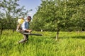 Senior farmer spraying the orchard Royalty Free Stock Photo