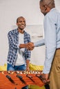 senior father and adult son shaking hands while playing table football Royalty Free Stock Photo