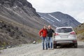 Senior father and adult son traveling together by car in mountains, off road driving on dirt road Royalty Free Stock Photo